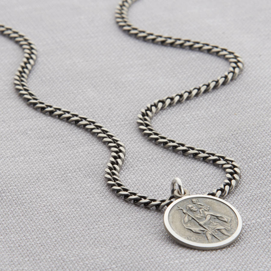 Silver curb chain necklace with a St Christopher pendant.