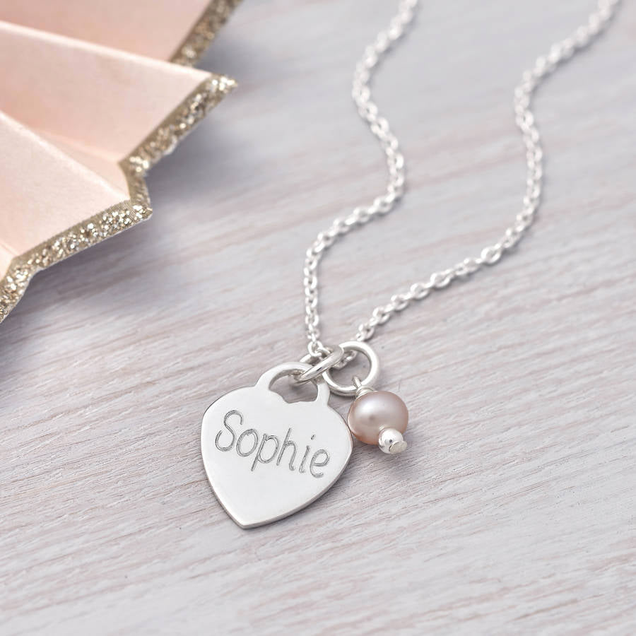 Silver engraved heart charm necklace with a freshwater pearl charm on.