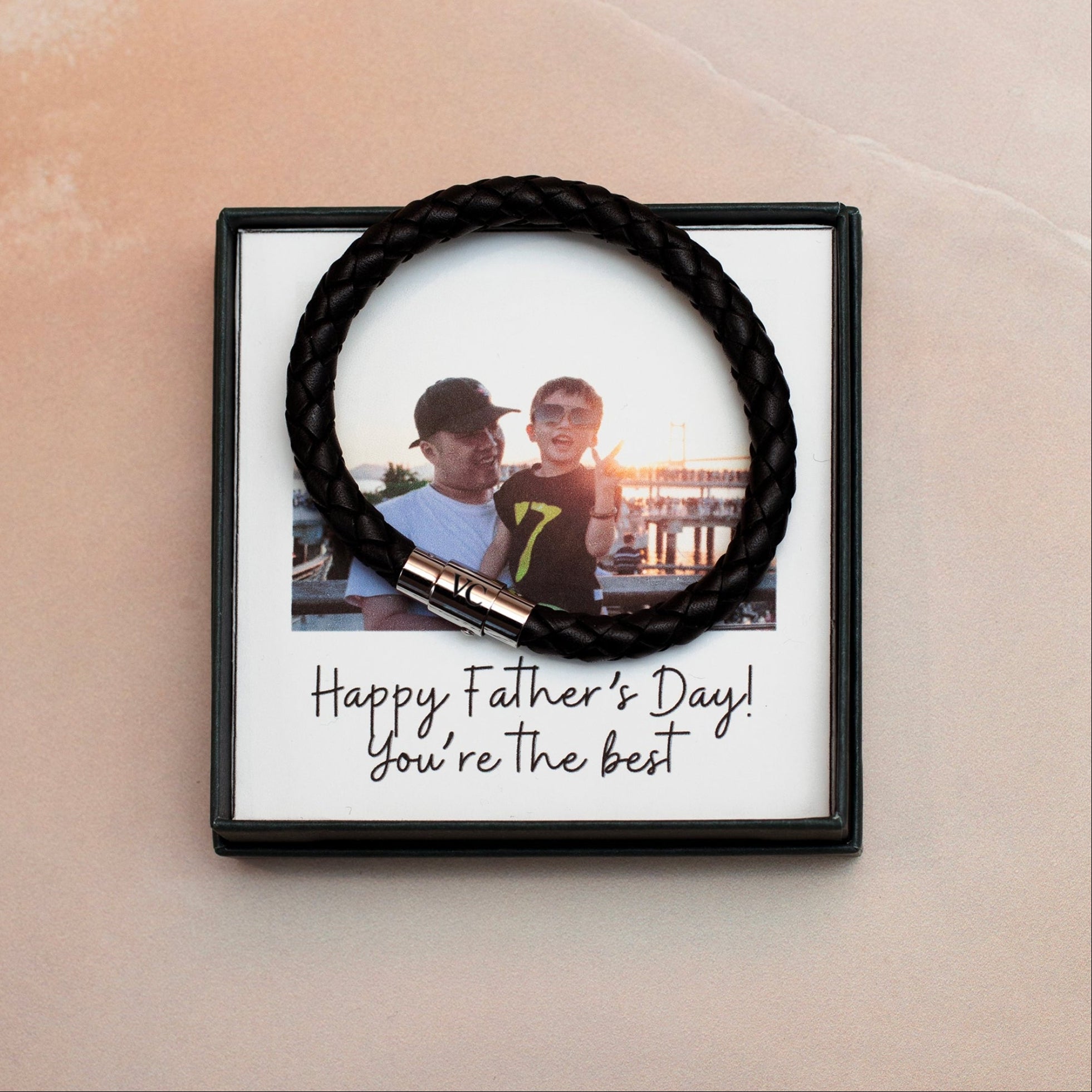 Framed photo of two boys with 'Happy Father's Day! You're the best!' text on a beige wall.