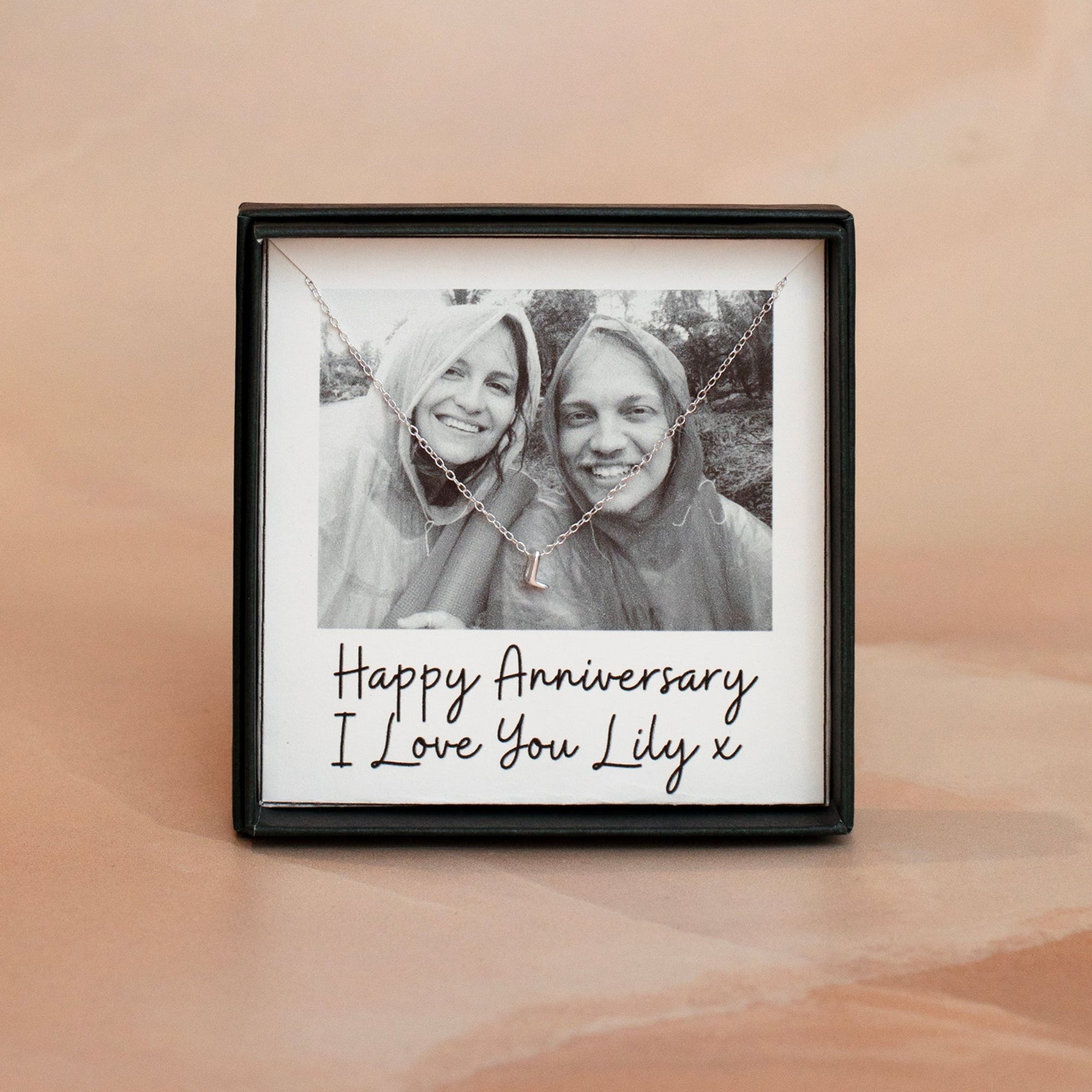 Framed photo of two people with a personalized message on a beige background